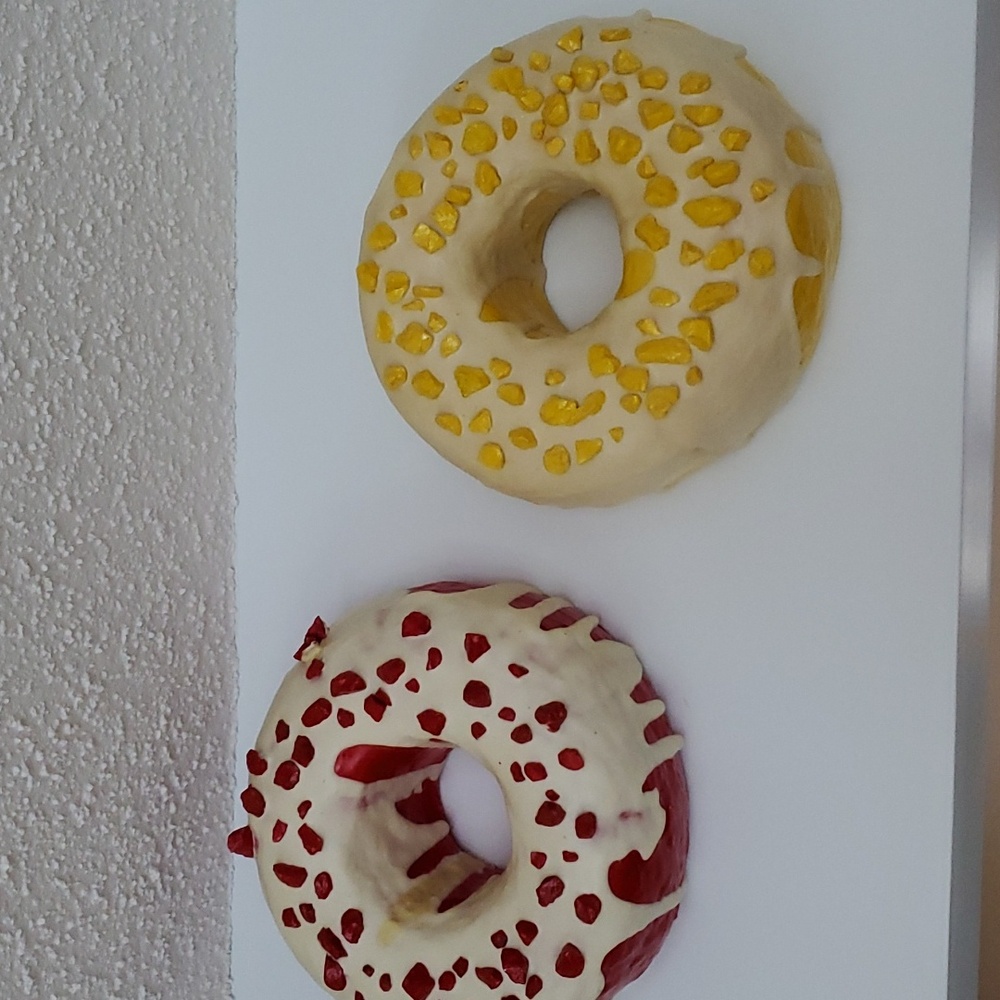 Two original donut wall sculptures artist Karess Pastore